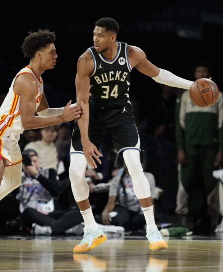 Dec 14, 2024; Las Vegas, Nevada, USA; Milwaukee Bucks forward Giannis Antetokounmpo (34) controls the ball against Atlanta Hawks forward Jalen Johnson (1) during the first quarter in a semifinal of the 2024 Emirates NBA Cup at T-Mobile Arena. Mandatory Credit: Kyle Terada-Imagn Images