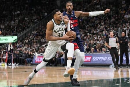 Dec 31, 2025; Milwaukee, Wisconsin, USA; Milwaukee Bucks forward Giannis Antetokounmpo (34) drives for the basket in front of Washington Wizards forward Alexandre Sarr (20) during the second quarter at Fiserv Forum. Mandatory Credit: Jeff Hanisch-Imagn Images
