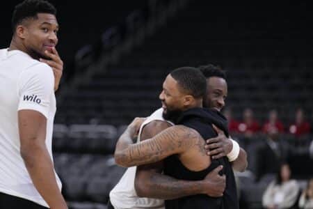 Nov 24, 2025; Milwaukee, Wisconsin, USA; Portland Trail Blazers and former Milwaukee Bucks guard Damian Lilliard (0), right talks gets a hug from Milwaukee Bucks forward Thannasis Antetokounmpo (43) as Milwaukee Bucks forward Giannis Antetokounmpo (34) looks on prior to their game at Fiserv Forum. Mandatory Credit: Michael McLoone-Imagn Images
