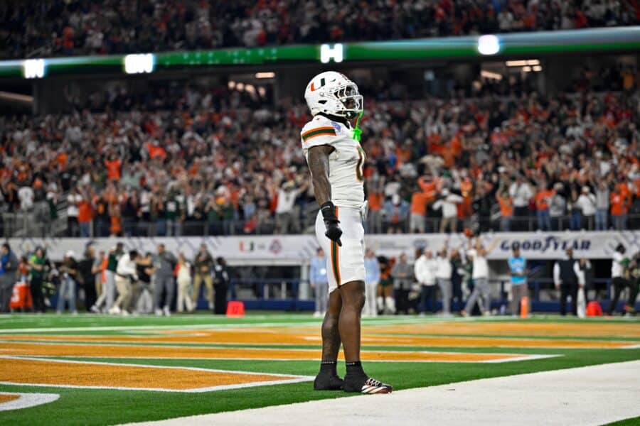 Dec 31, 2025; Arlington, TX, USA; Miami Hurricanes defensive back Keionte Scott (0) celebrates after he returns an interception for a touchdown during the 2025 Cotton Bowl and quarterfinal game of the College Football Playoff at AT&T Stadium. Mandatory Credit: Jerome Miron-Imagn Images